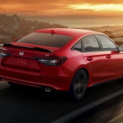 Red Honda sedan driving on highway at sunset