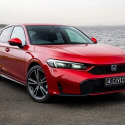 Red Honda Civic sedan parked by the water